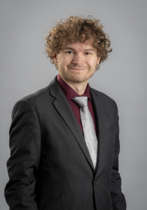 A man smiling lightly. 